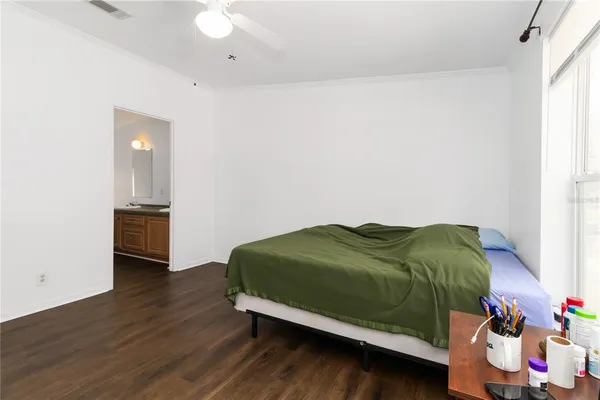 a bedroom with a bed and a window