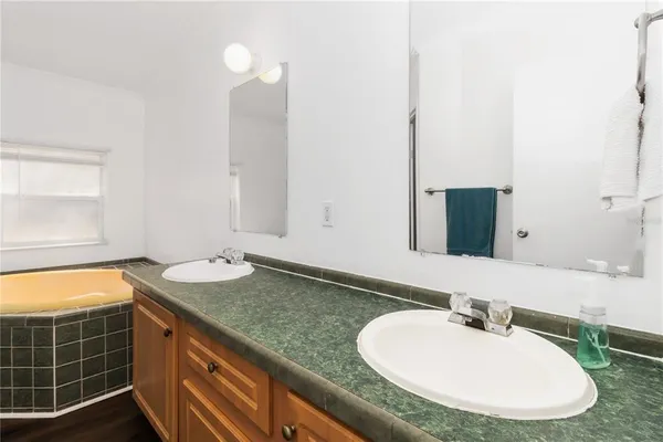 a bathroom with a granite countertop sink and a mirror
