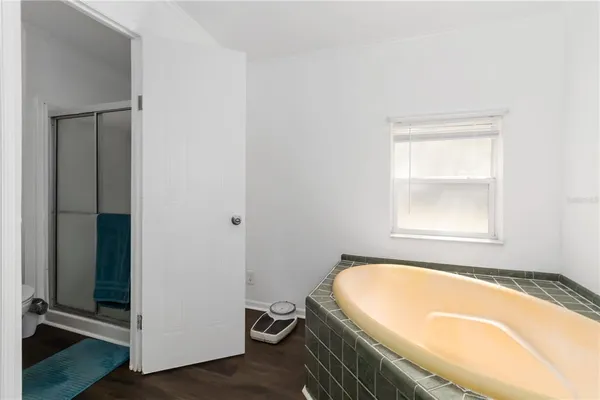 a bathroom with a tub and a window