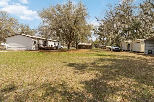 a view of a white house with a yard