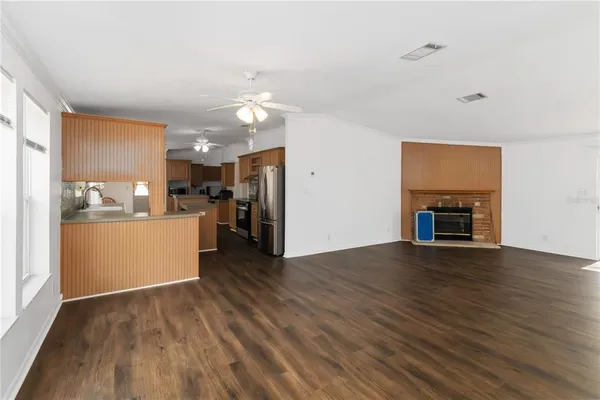 a view of a kitchen with a sink and a refrigerator