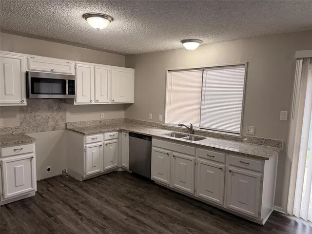 a kitchen with sink cabinets and microwave
