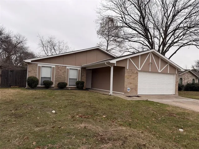 a house that has a tree in front of it