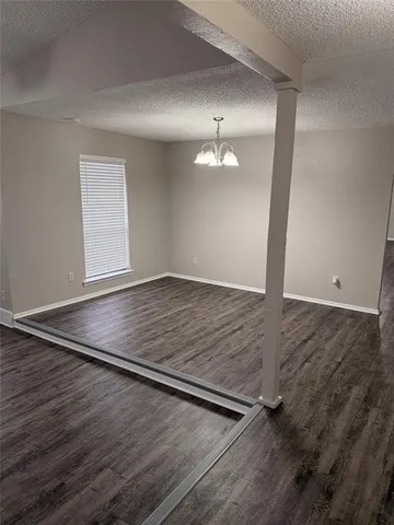 an empty room with wooden floor