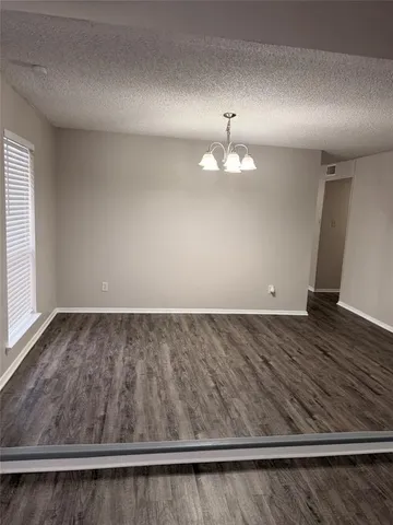 an empty room with wooden floor