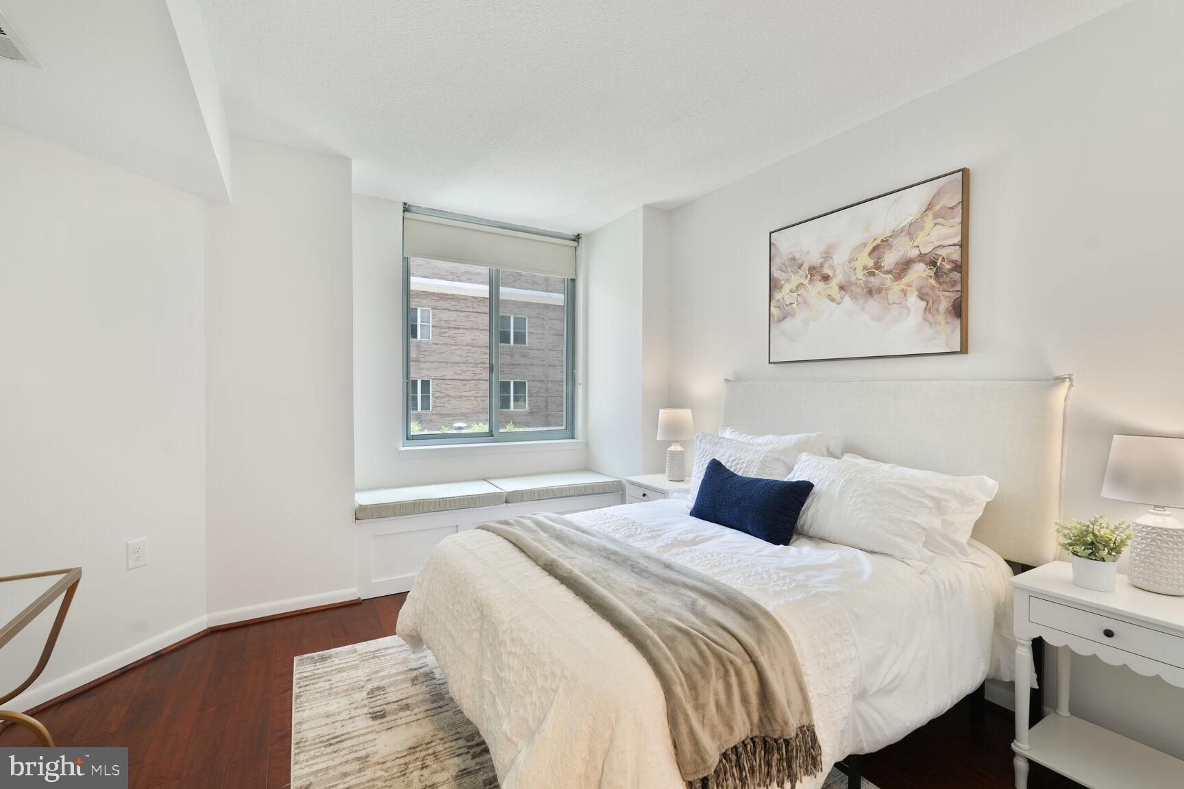 851 North Glebe Road, Unit 409 Arlington, VA 22203 - Photo 11 of 26 a bedroom with bed and wooden floor