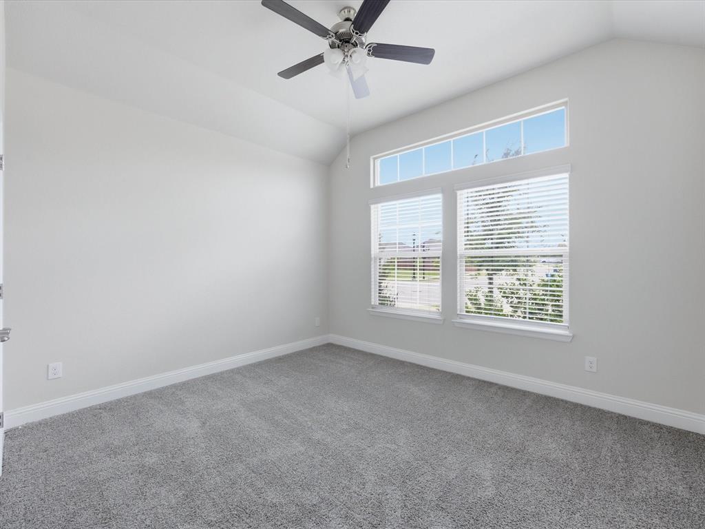 1121 Knightsbridge Road Argyle, TX 76226 - Photo 14 of 39 Vaulted ceiling room featuring a contemporary ceiling fan, grey carpeting, and white baseboards