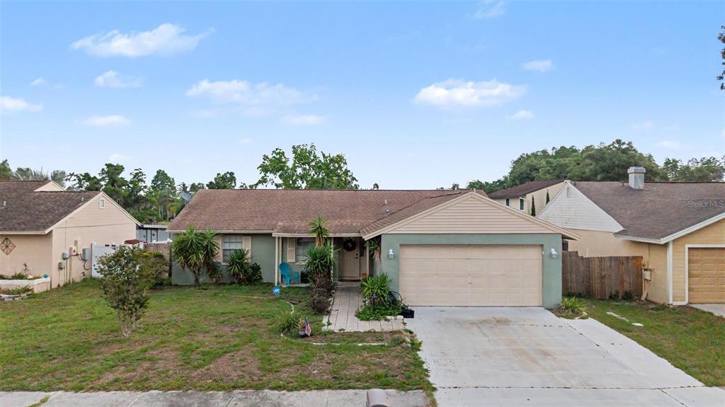 1632 Pintail Court Lutz, FL 33549 - Photo 2 of 34 a front view of a house with a yard and garage