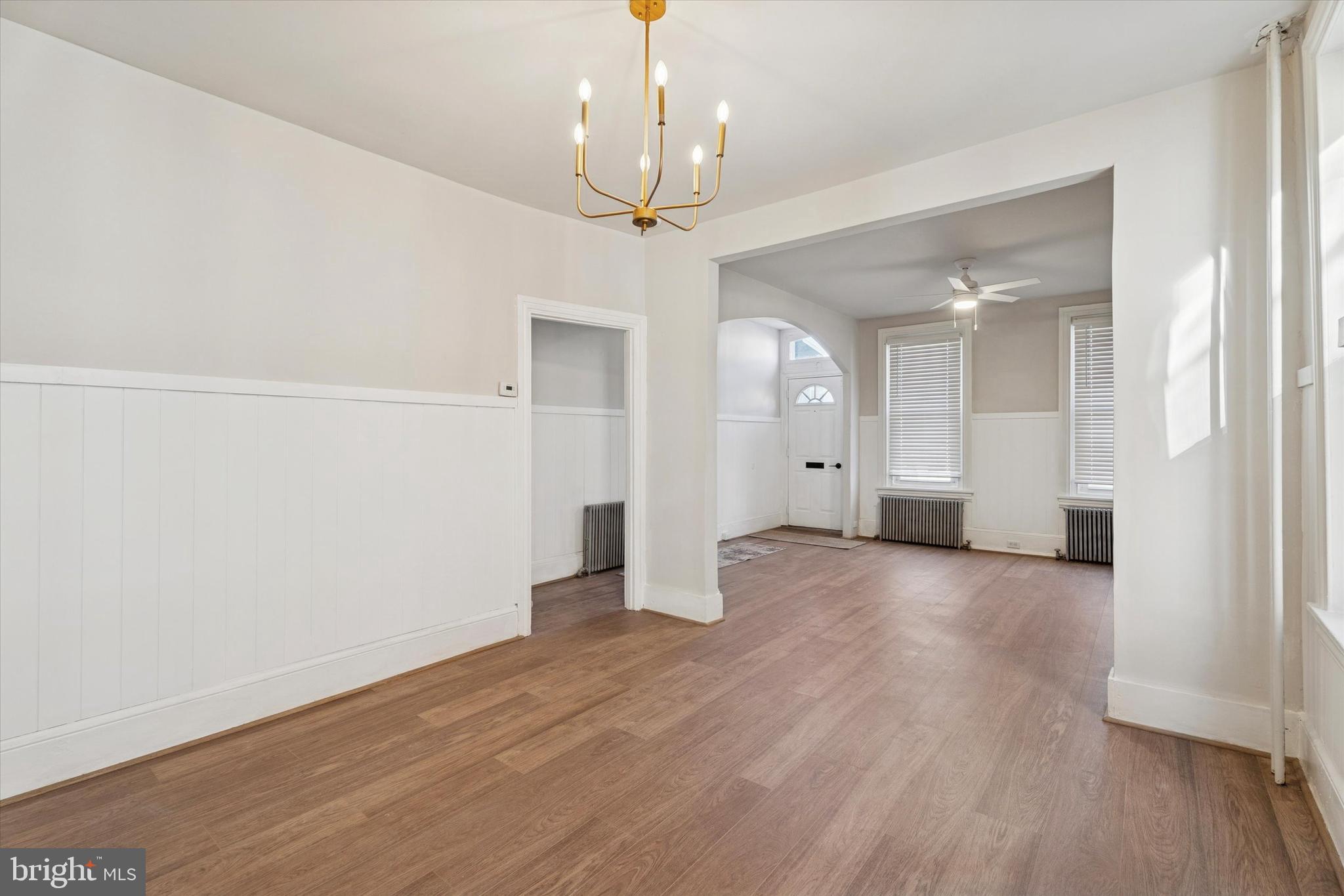 810 George Street Norristown, PA 19401 - Photo 4 of 15 an empty room with wooden floor chandelier and windows