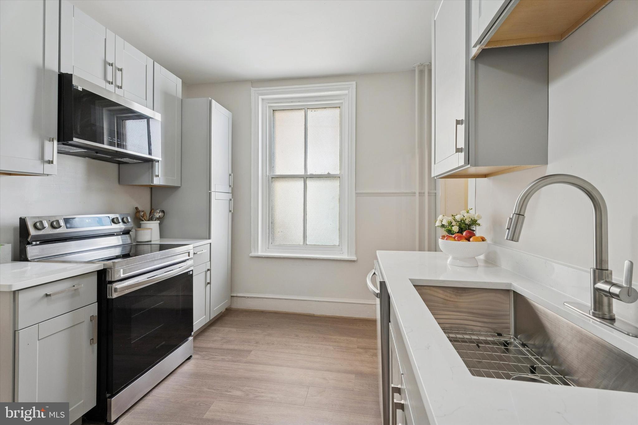 810 George Street Norristown, PA 19401 - Photo 5 of 15 a kitchen with stainless steel appliances granite countertop a sink stove and cabinets