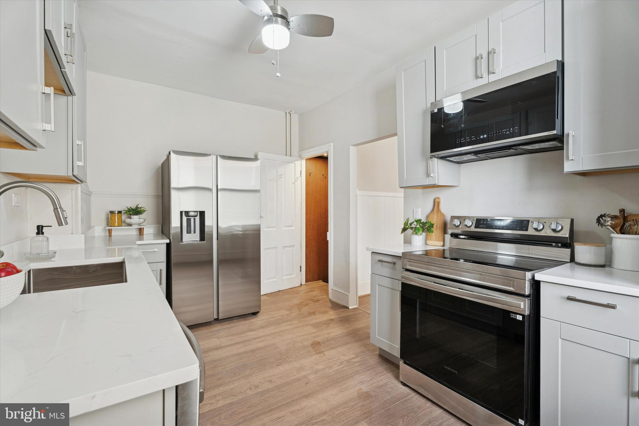 810 George Street Norristown, PA 19401 - Photo 6 of 15 a kitchen with stainless steel appliances a stove microwave and sink