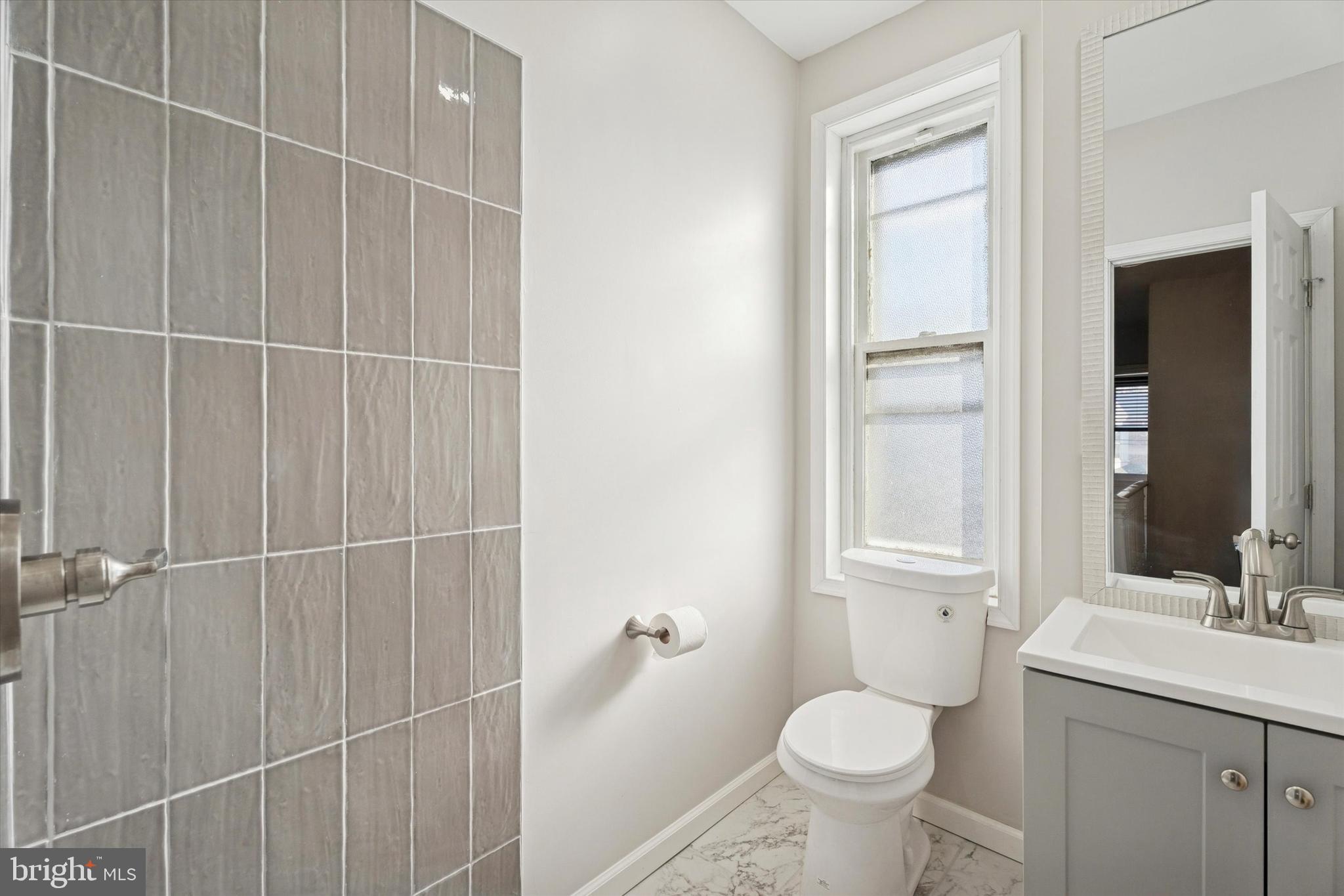810 George Street Norristown, PA 19401 - Photo 9 of 15 a bathroom with a toilet sink and mirror