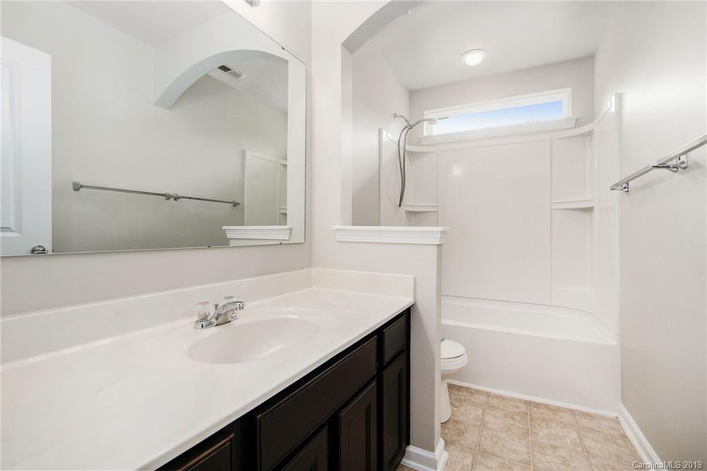 10244 Withers Road Charlotte, NC 28278 - Photo 11 of 17 a bathroom with a sink vanity granite tub shower and mirror