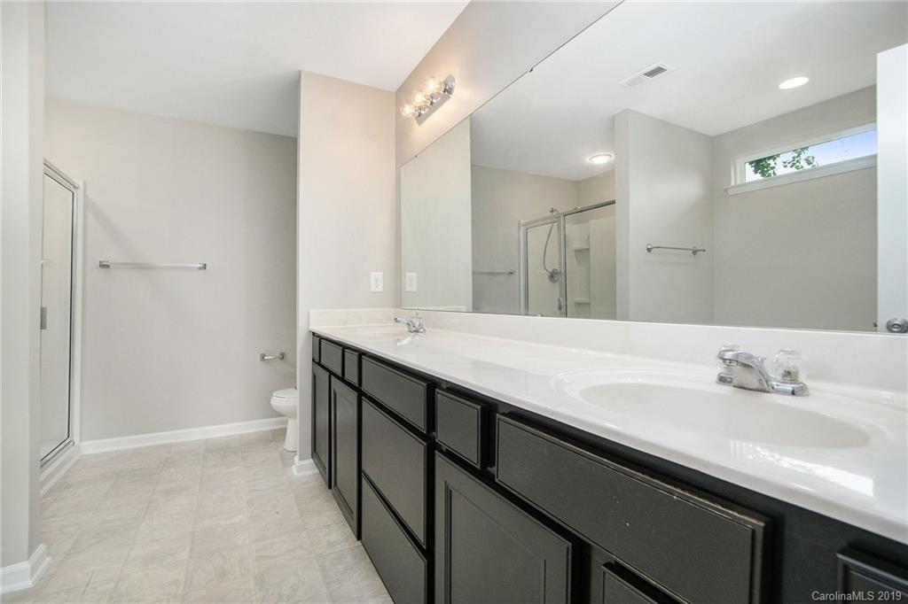 10244 Withers Road Charlotte, NC 28278 - Photo 16 of 17 a bathroom with a double vanity sink a and a mirror