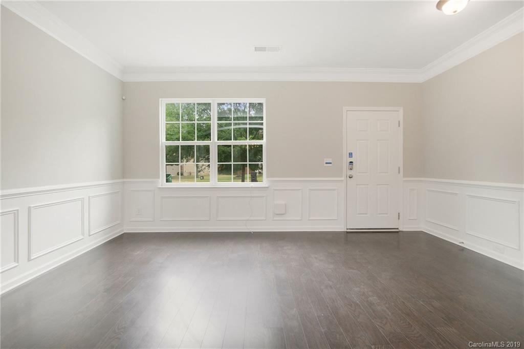 10244 Withers Road Charlotte, NC 28278 - Photo 3 of 17 an empty room with wooden floor and windows