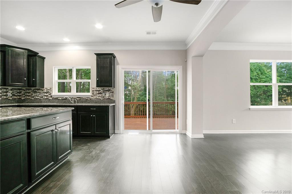 10244 Withers Road Charlotte, NC 28278 - Photo 7 of 17 a kitchen with stainless steel appliances granite countertop a stove and a wooden floors