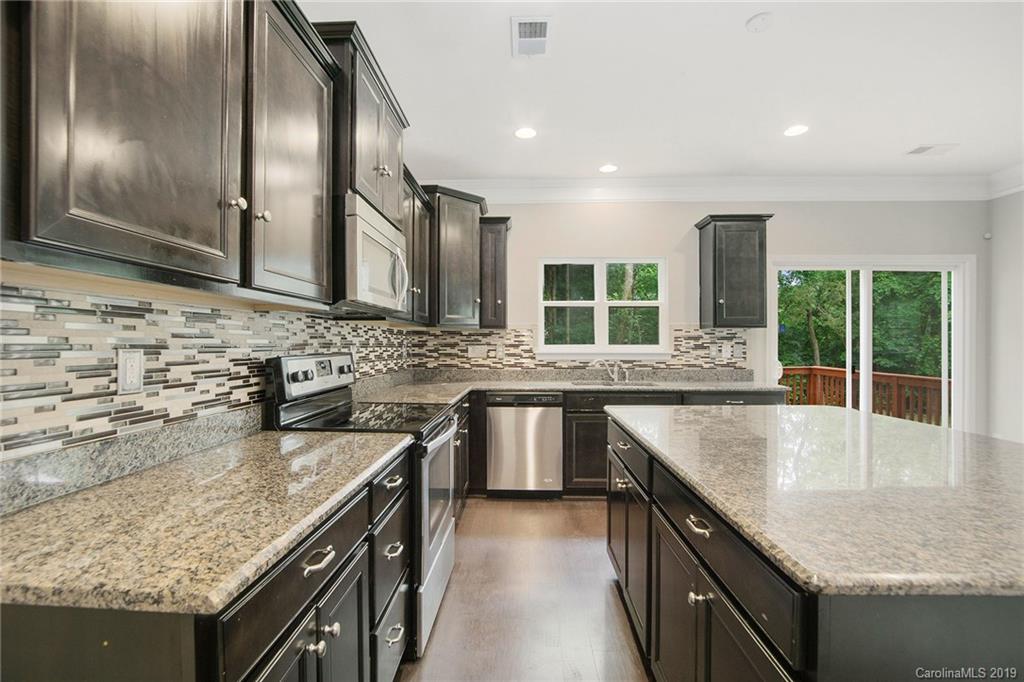 10244 Withers Road Charlotte, NC 28278 - Photo 8 of 17 a kitchen with stainless steel appliances granite countertop a sink a stove and a wooden cabinets