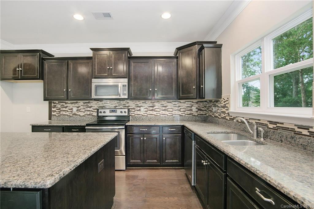 10244 Withers Road Charlotte, NC 28278 - Photo 9 of 17 a kitchen with stainless steel appliances granite countertop a sink stove and cabinets