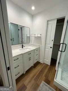 a spacious bathroom with a double vanity sink a mirror and a shower