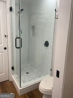 a bathroom with a shower and toilet