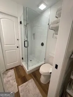 a bathroom with a toilet and a shower
