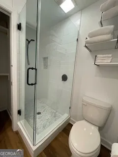 a white toilet next to a bathroom