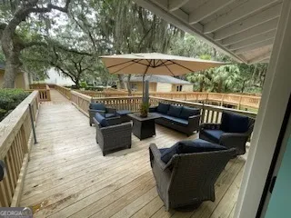 a terrace with outdoor seating and wooden floor
