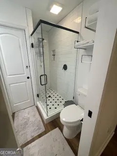 a bathroom with a toilet and shower
