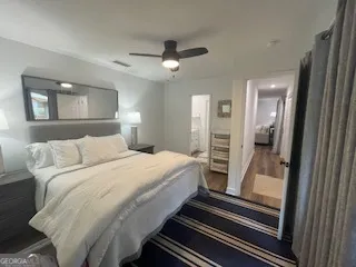a bedroom with a bed and a refrigerator