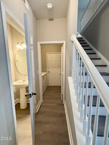 a view of a hallway with wooden floor and entryway