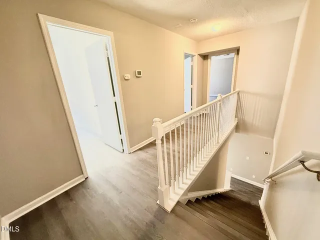 a view of a hallway with staircase