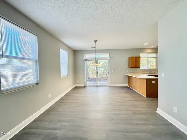 a big room with chandelier and windows