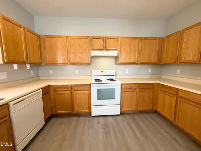 a kitchen with a stove top oven sink and cabinets