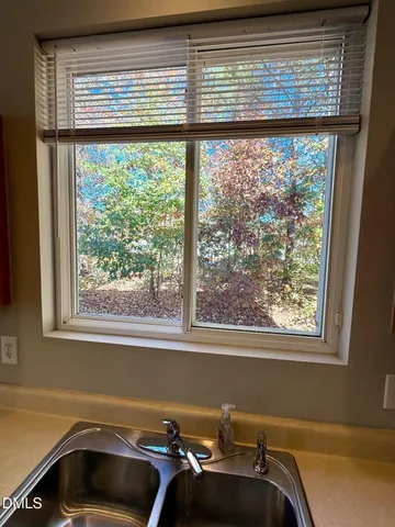 a view of a room that has a bed and a window