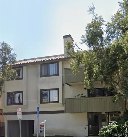 a front view of a house with plants
