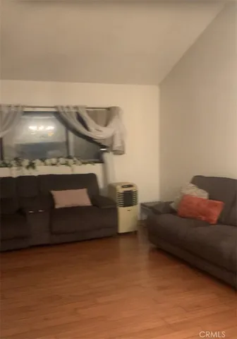 a living room with furniture and a pool table