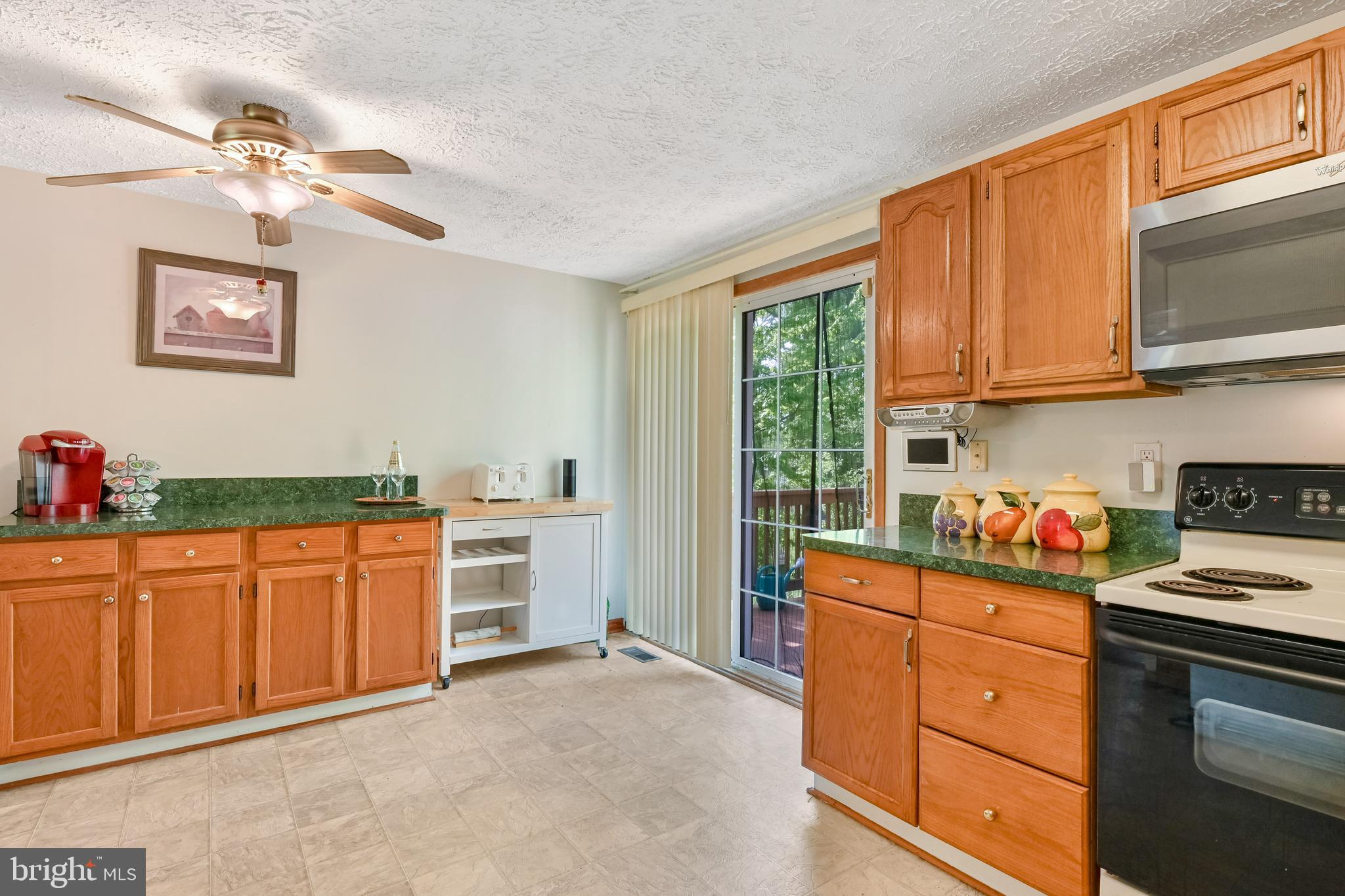 317 McKay Road Stevensville, MD 21666 - Photo 11 of 58 Kitchen & dining area leads to deck beyond