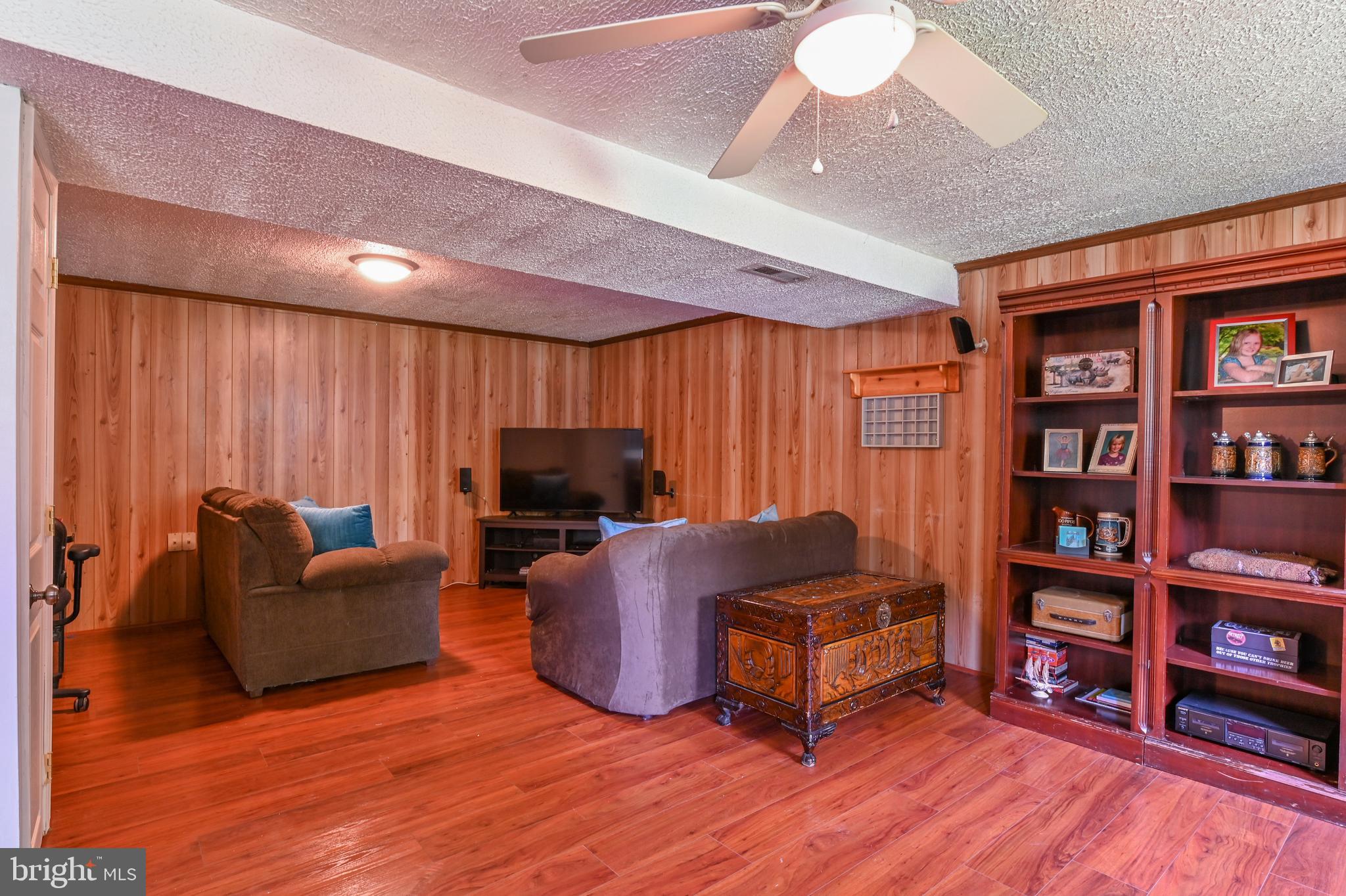 317 McKay Road Stevensville, MD 21666 - Photo 25 of 58 Lower level with laminate & ceiling fan