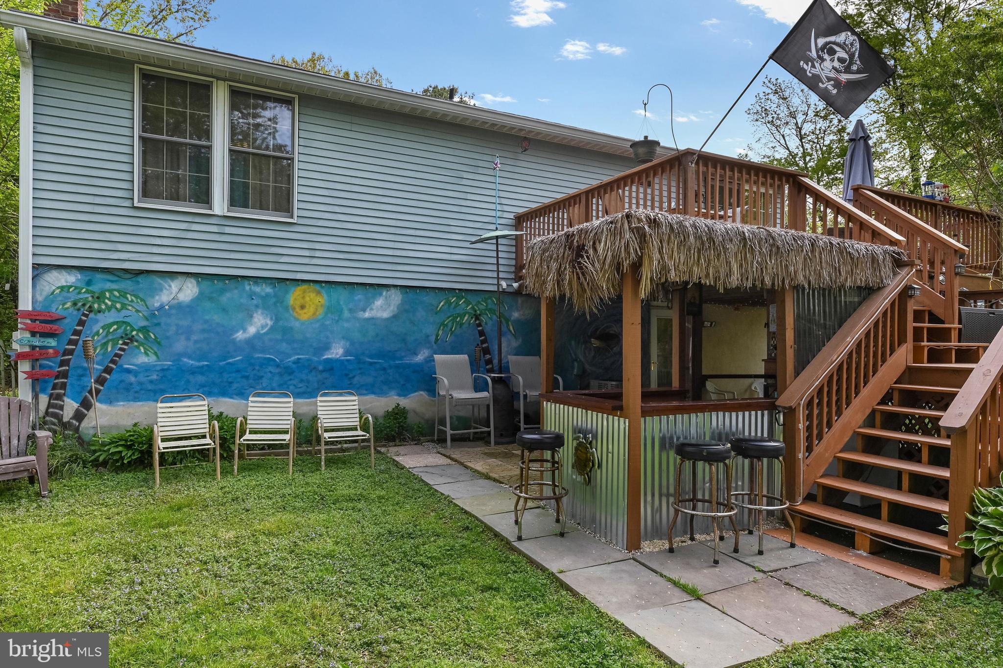 317 McKay Road Stevensville, MD 21666 - Photo 38 of 58 Deck to tiki bar with seaside mural