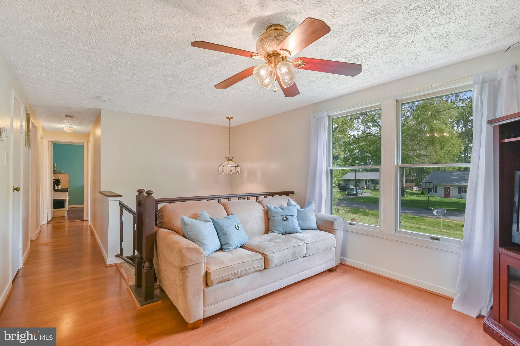 317 McKay Road Stevensville, MD 21666 - Photo 8 of 58 Living room with laminate flooring & ceiling fan