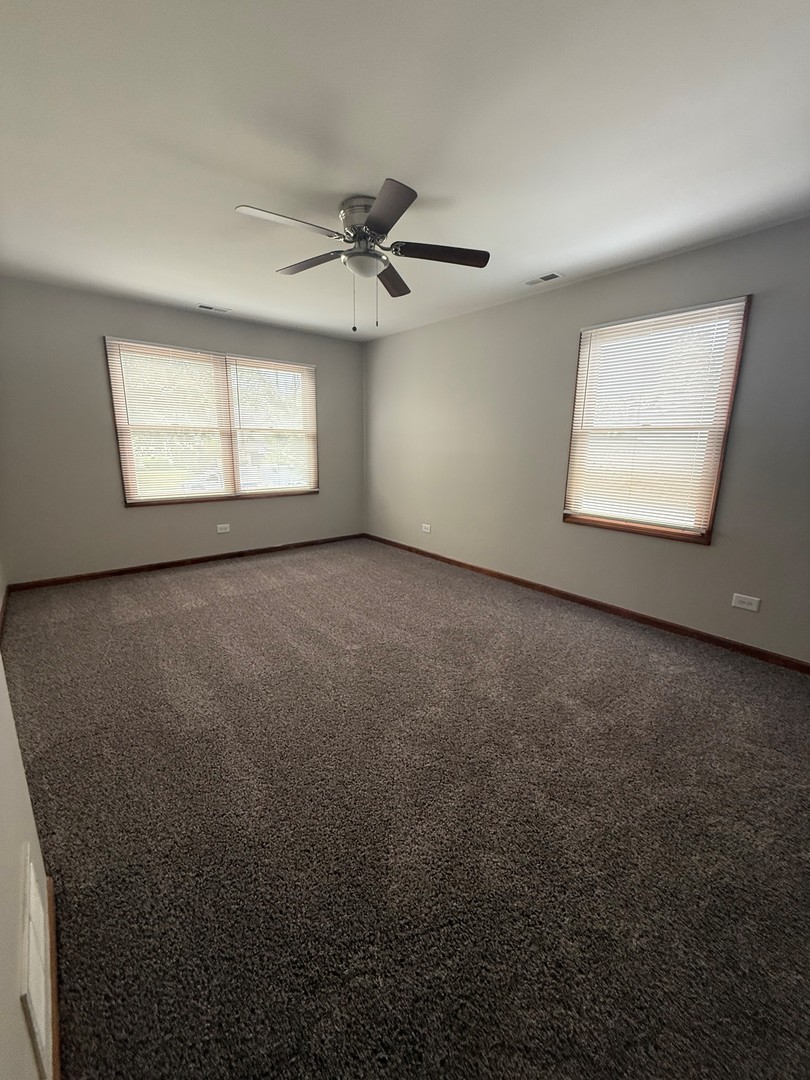 674 East Algonquin Road Des Plaines, IL 60016 - Photo 11 of 19 an empty room with windows and fan