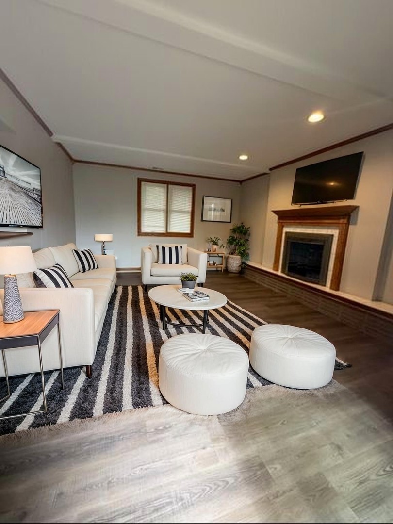 674 East Algonquin Road Des Plaines, IL 60016 - Photo 9 of 19 a living room with furniture and a fireplace