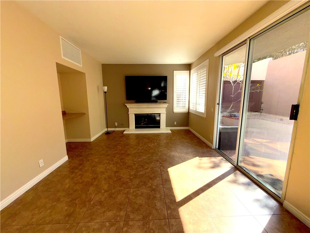 1053 Regatta Costa Mesa, CA 92627 - Photo 11 of 24 a living room with a flat screen tv and a fireplace