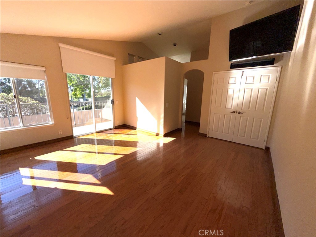 1053 Regatta Costa Mesa, CA 92627 - Photo 13 of 24 a view of a livingroom with wooden floor and a flat screen tv