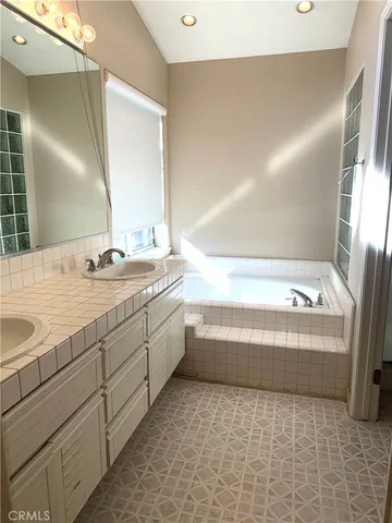 a bathroom with a bathtub and a sink