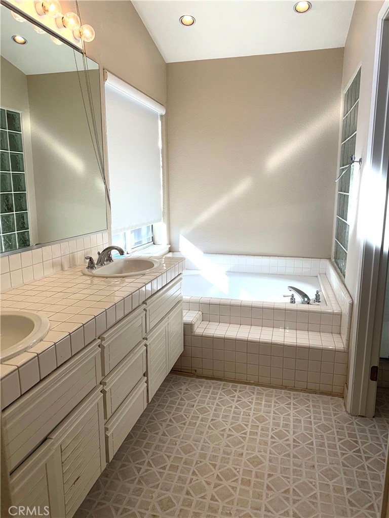 1053 Regatta Costa Mesa, CA 92627 - Photo 14 of 24 a bathroom with a bathtub and a sink
