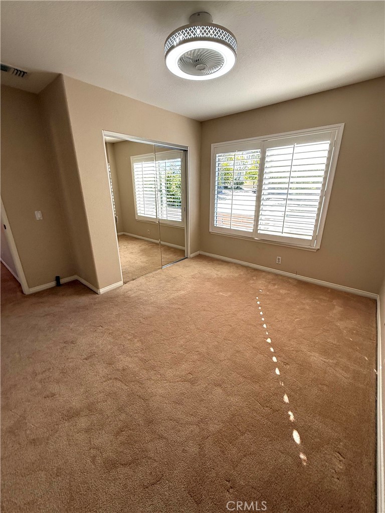 1053 Regatta Costa Mesa, CA 92627 - Photo 18 of 24 en empty room with windows and ceiling fan
