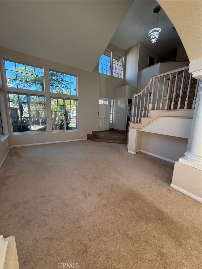 1053 Regatta Costa Mesa, CA 92627 - Photo 7 of 24 a view of an empty room with windows & staircase