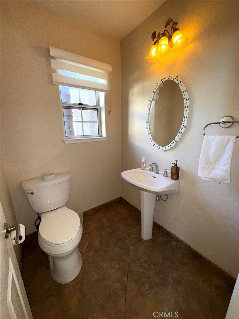1053 Regatta Costa Mesa, CA 92627 - Photo 10 of 24 a bathroom with a toilet sink and mirror