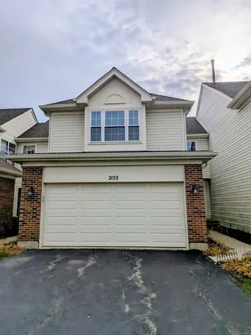 a front view of a house with a garage